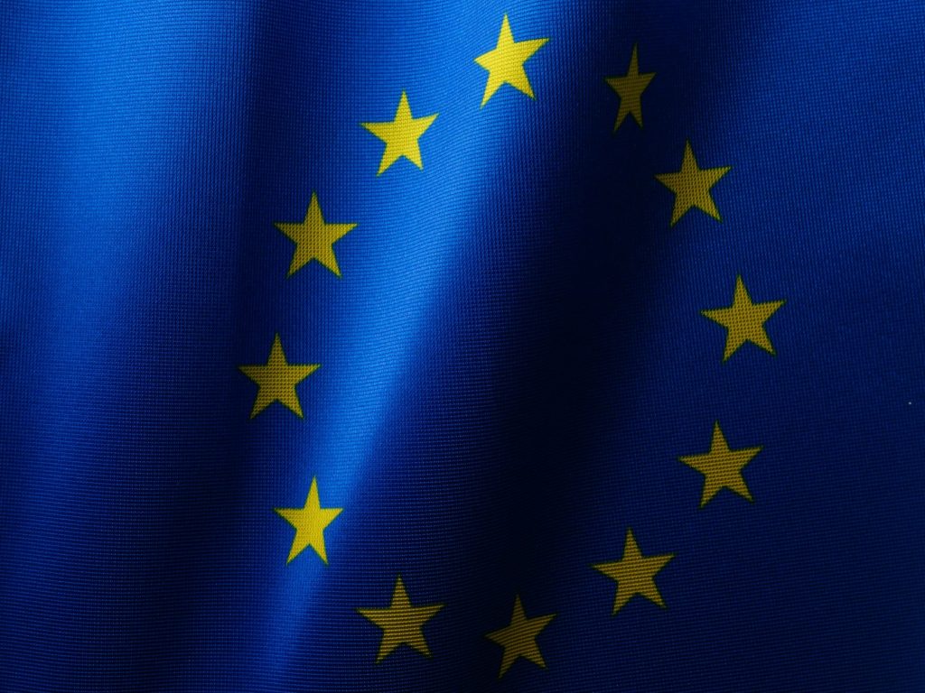 Flag of the EU as the European Commission has seen a flood of interest from companies looking to help create AI Gigafactories across Europe develop and train the next generation of artificial intelligence systems.
